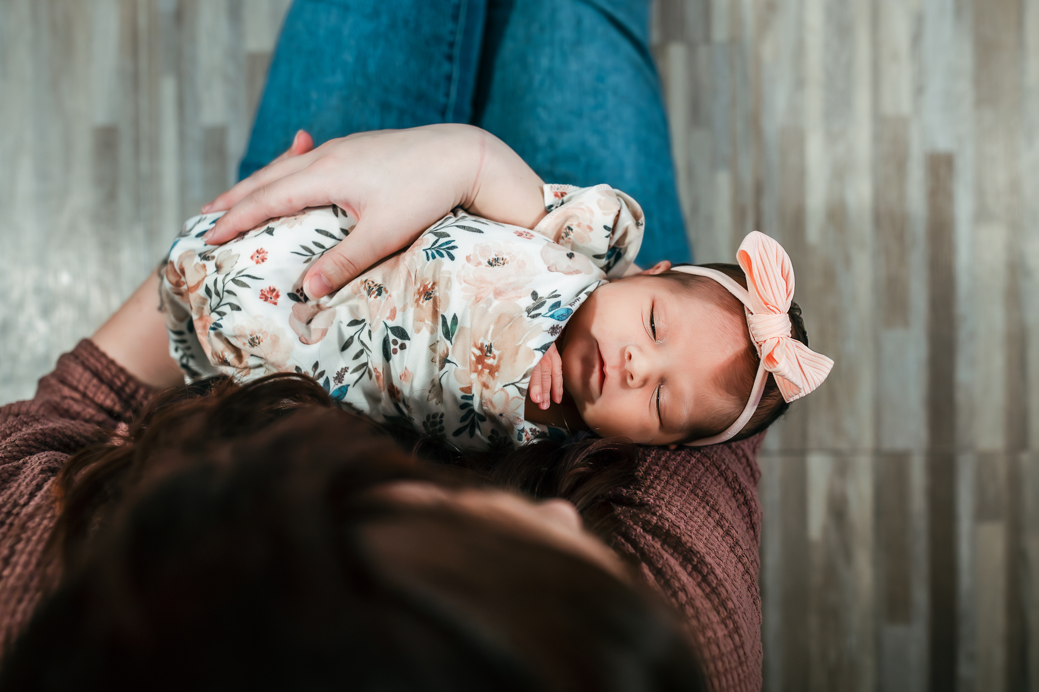 Newborn baby is held by her mom