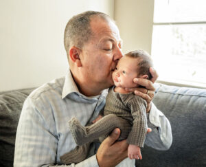 Grandpa kisses his brand new baby grandson in Modesto, CA