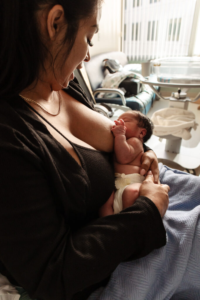 A new mom breastfeeds her baby in a hospital 