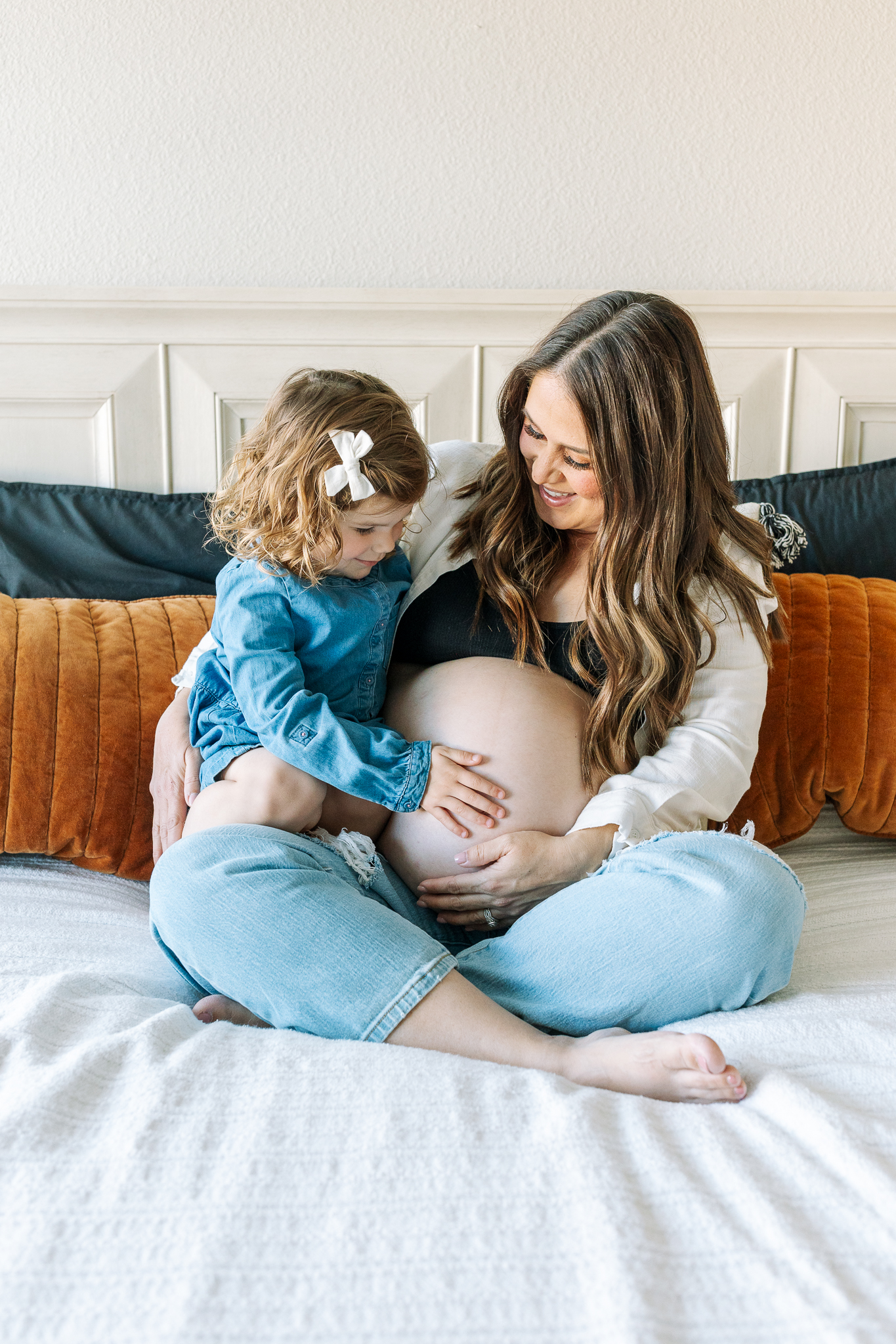 A little girl spends time with her pregnant mother as they prepare for a mommy and me class in modesto