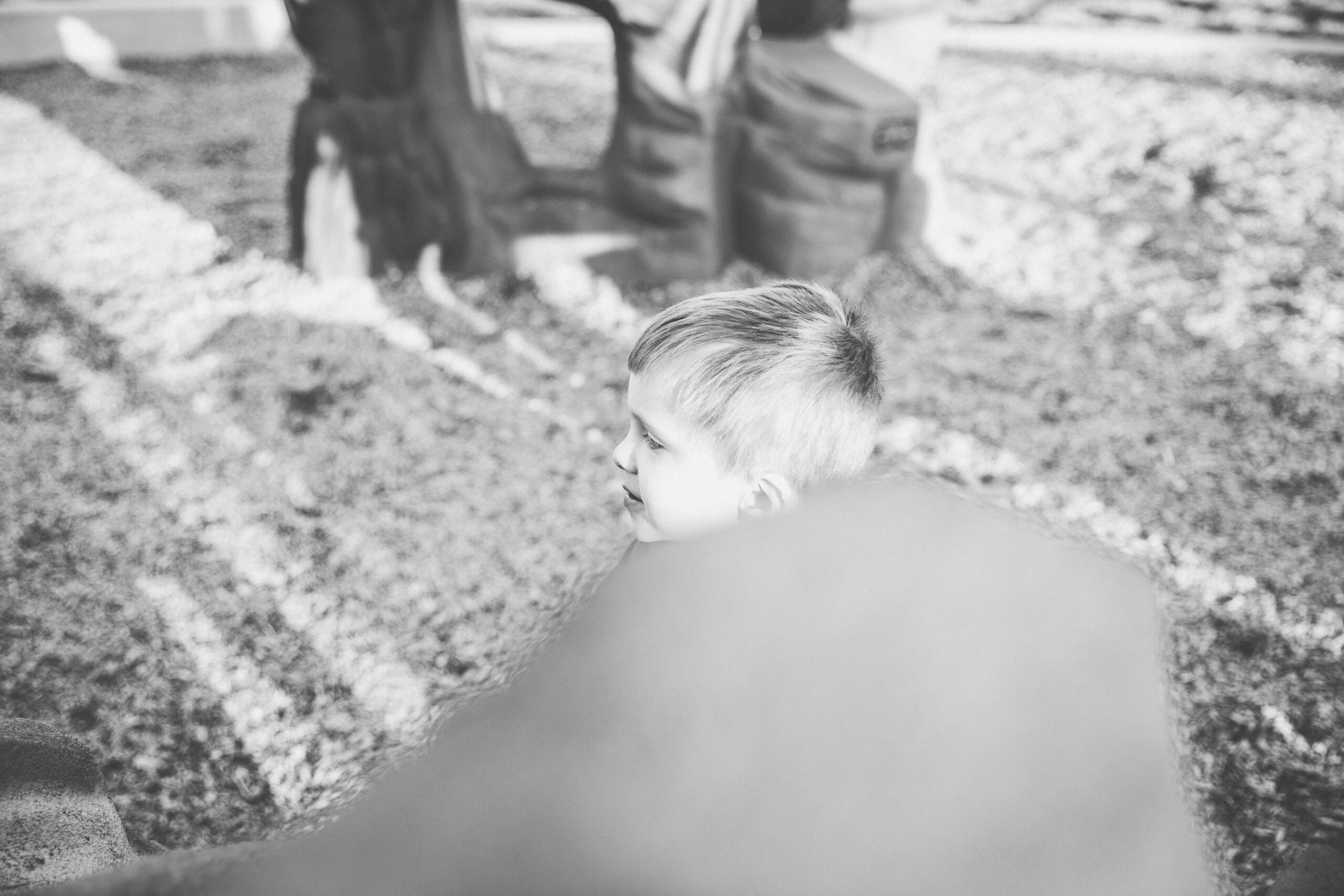 a little boy emerges out of a slide on one of the many playgrounds in modesto, ca